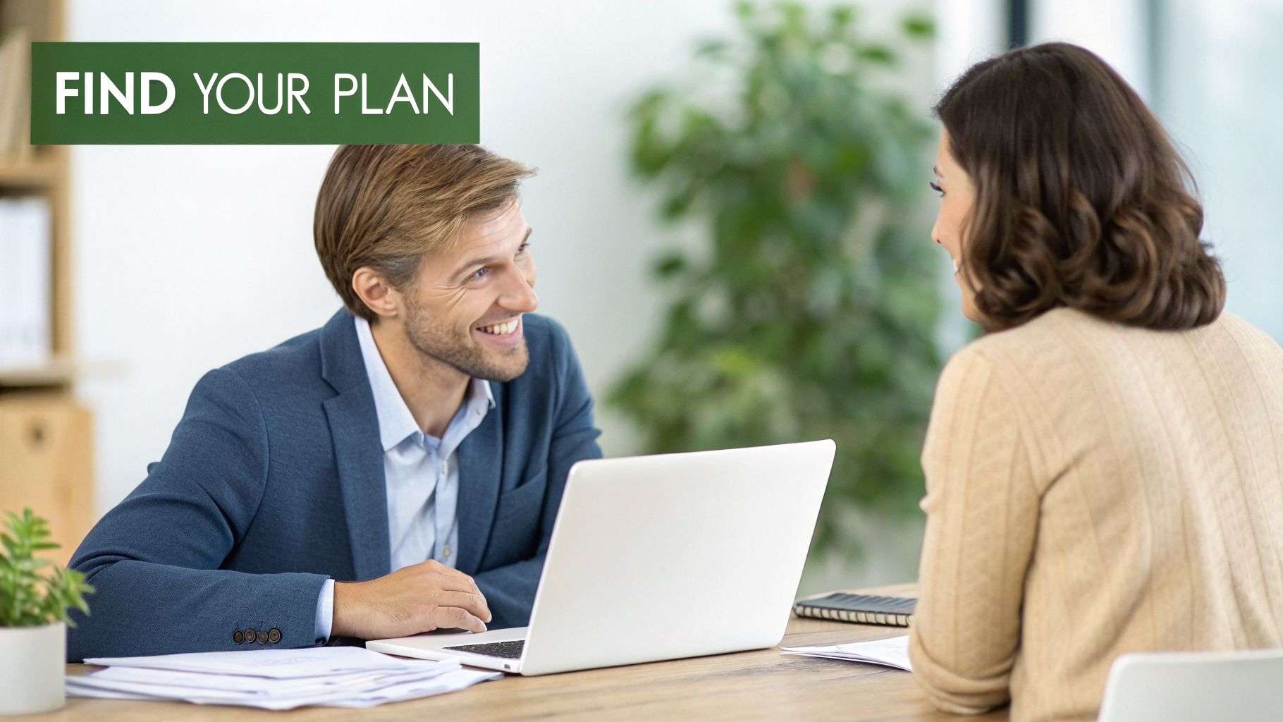 A smiling man in a suit talks to a woman at a desk with a laptop, banner says "FIND YOUR PLAN".