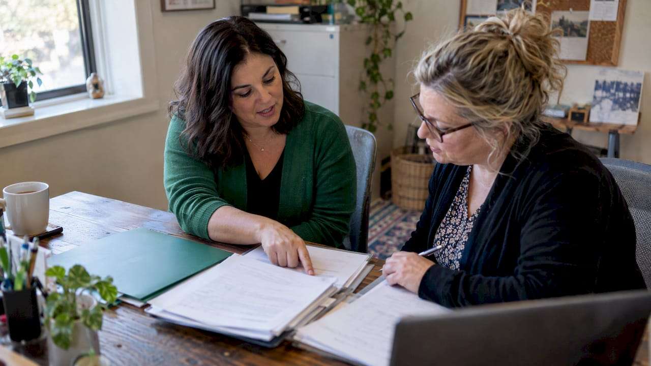 Small-business owner reviewing health-care tax paperwork