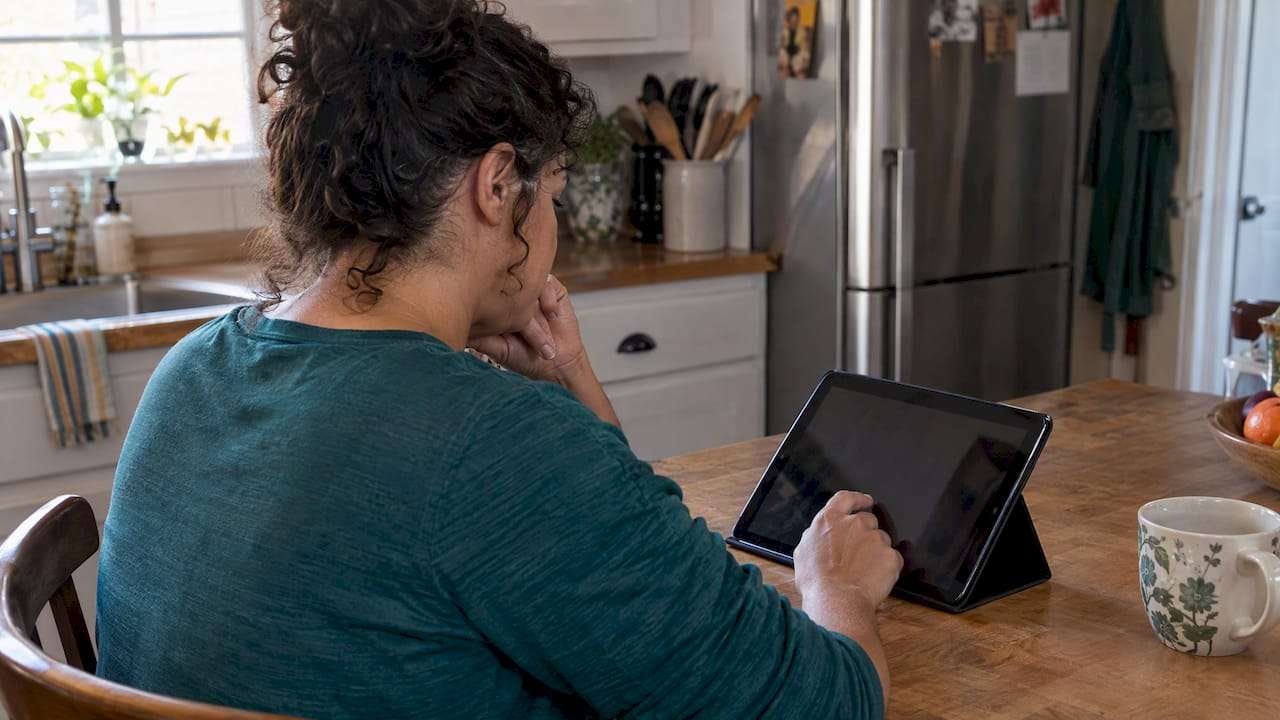 1792037404282_Woman-reviewing-a-Marketplace-application-at-home - Pounds Health Woman reviewing a Marketplace application at home